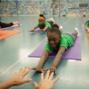 A child stretches out on a yoga mat. thumbnail