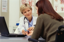 A physician consulting with a patient. A physician consulting with a patient.