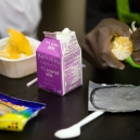 Young girls enjoy a healthy lunch in their school cafeteria. thumbnail
