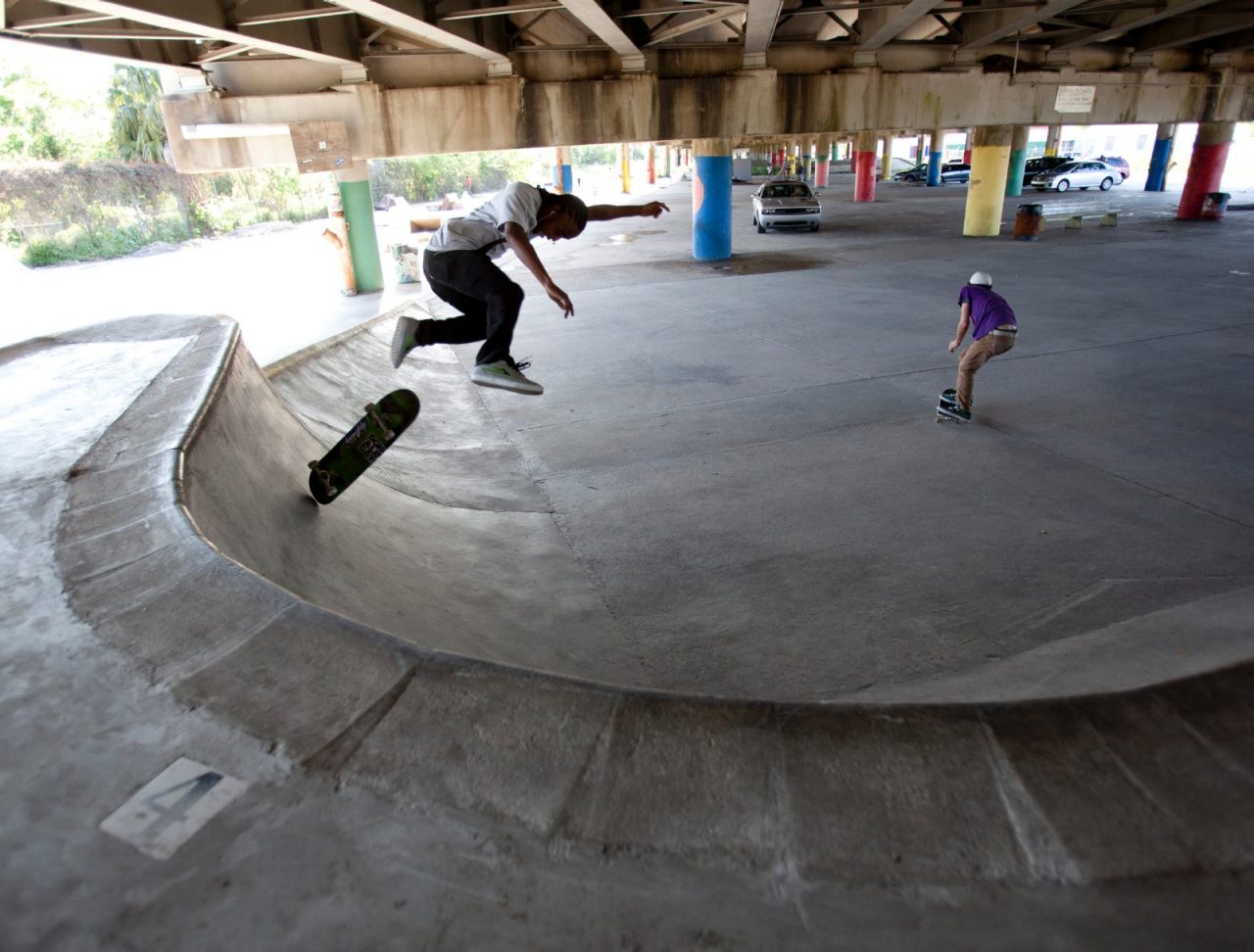 Youth using a public skateboard ramp underneath the I-610 overpass.