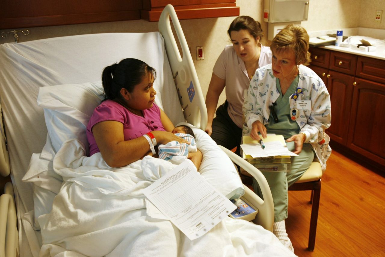 Interpreter Heather Cazarin helps nurse Barbara Heintz communicate with a new mother. AnMed Health, Anderson, S.C. MedVerse - Hablamos Juntos