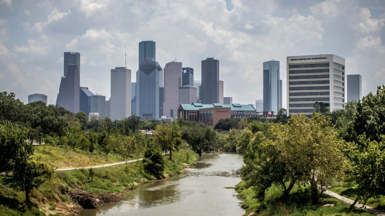 A landscape of a city near a river.