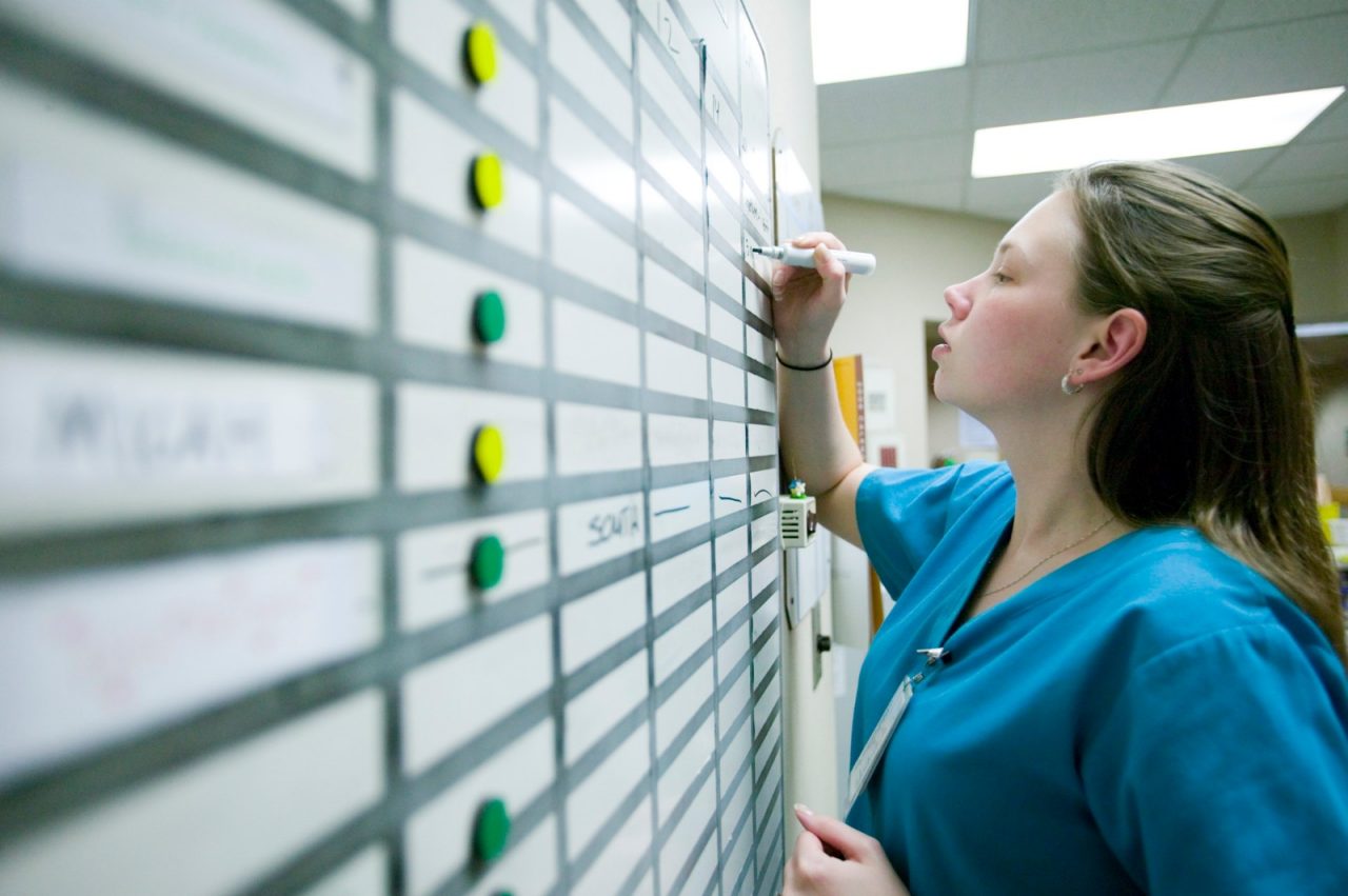 Nicole Hoppe, RN, checks the Status Board at a nurses' station on medical surgical floor of Seton Northwest Hospital, Austin, Texas. Transforming Care at the Bedside.
