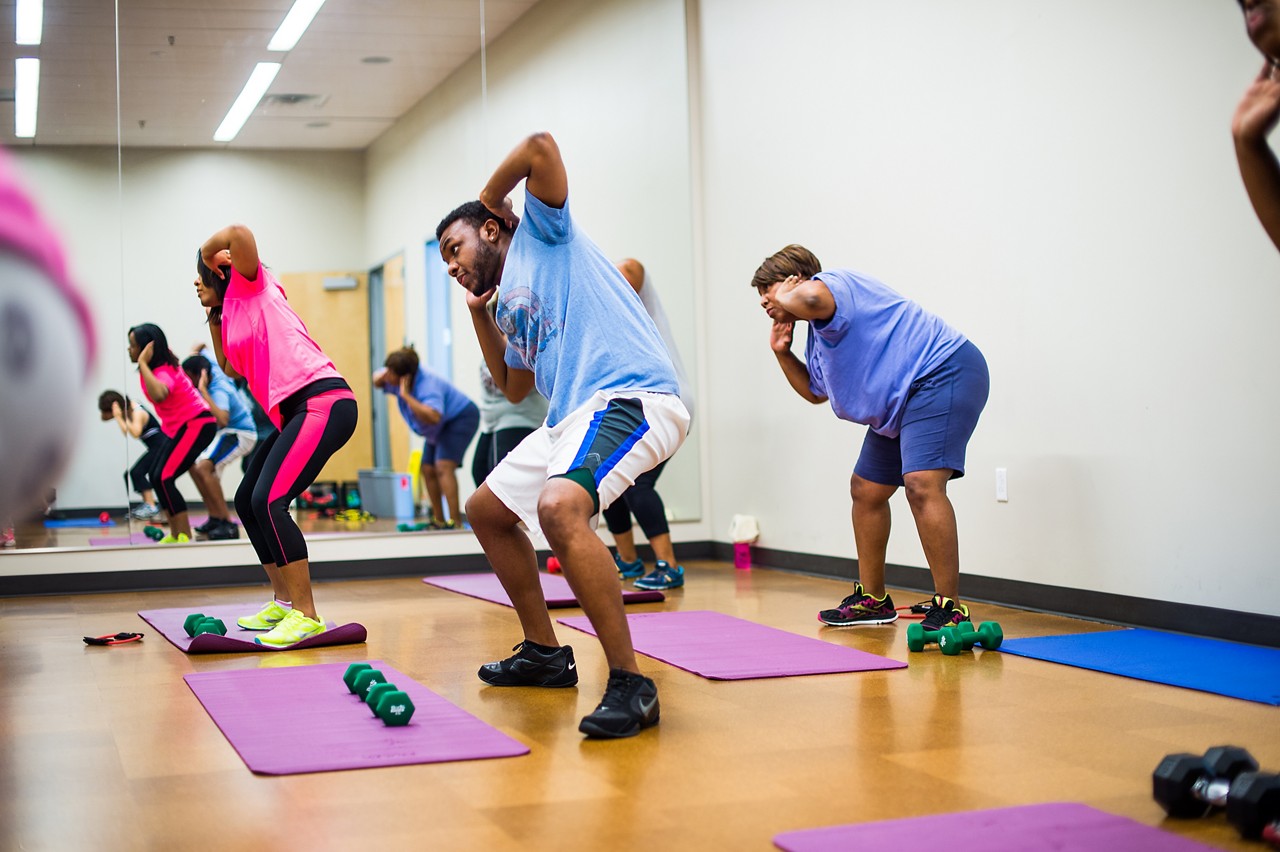 Adults exercising at a community class. Adults exercising at a community class.
