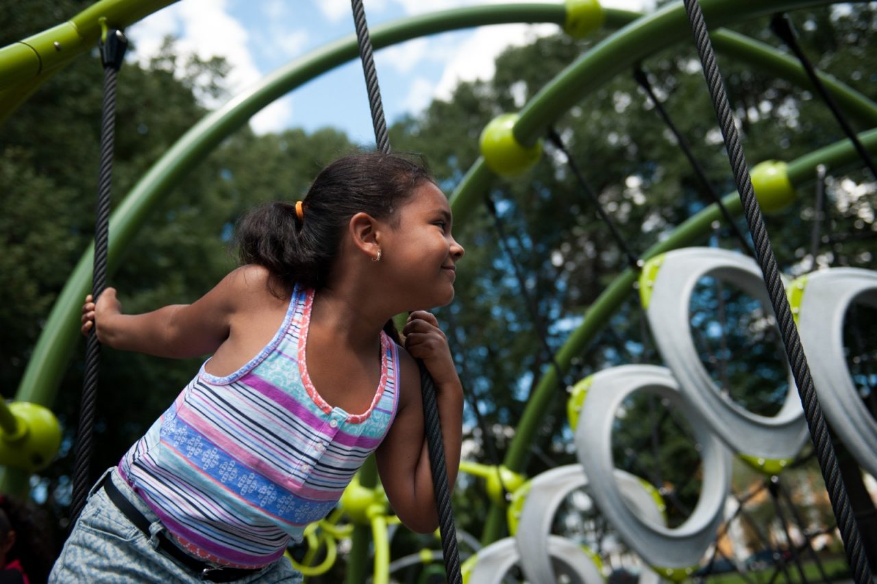 Valerie De Los Santos, 6, climbs on the jungle gym in the new playground in Lawrence's Campagnone Common on a Sunday afternoon.