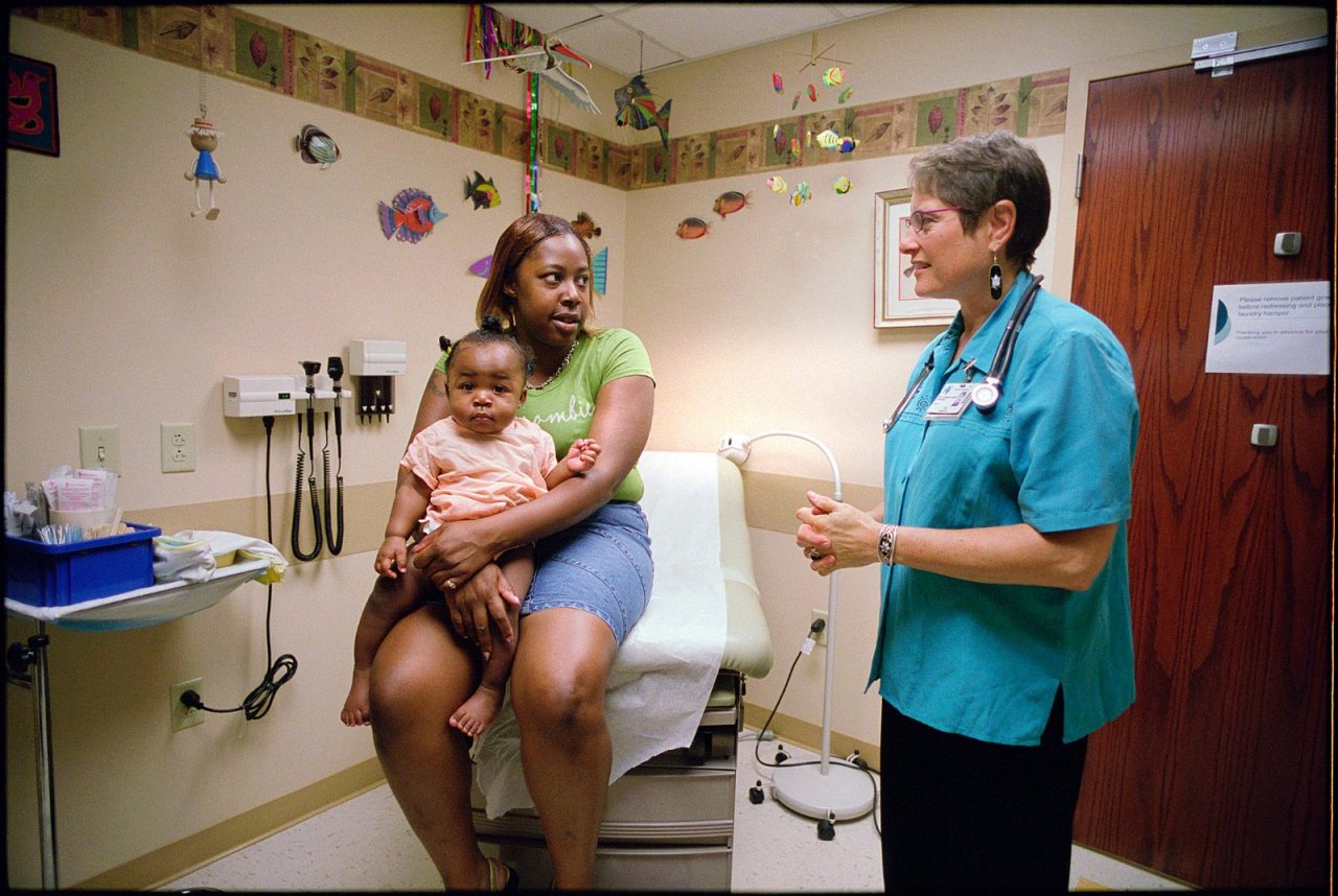 Dr. Lisa Brand, a pediatrician at the MetroHealth Center in Cleveland speaks with a mother who holds her infant daughter. Community Advocacy Project.  Cleveland, Ohio. CAP. (Edited)