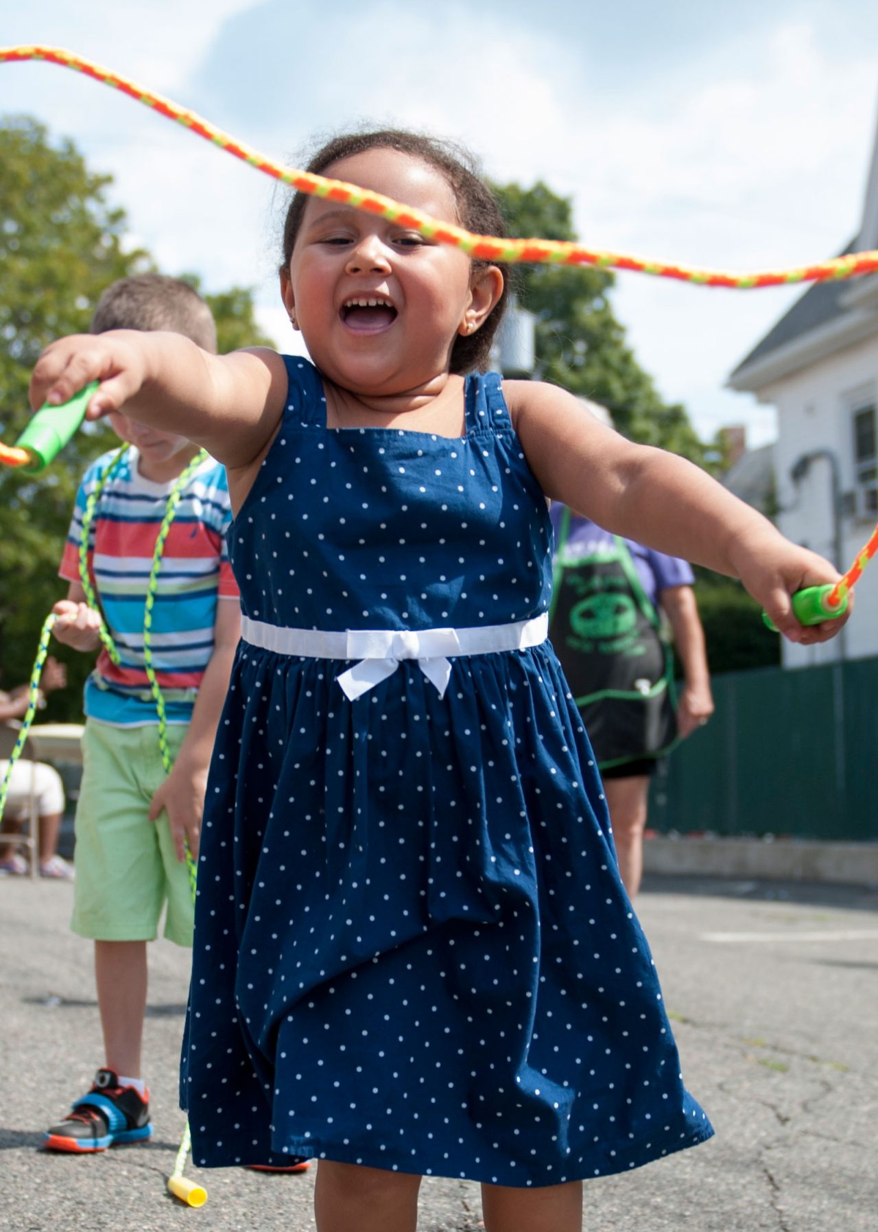 A girl in a blue dress jumping rope. A girl in a blue dress jumping rope.