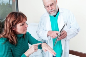 A patient goes over app-based data with her clinician.