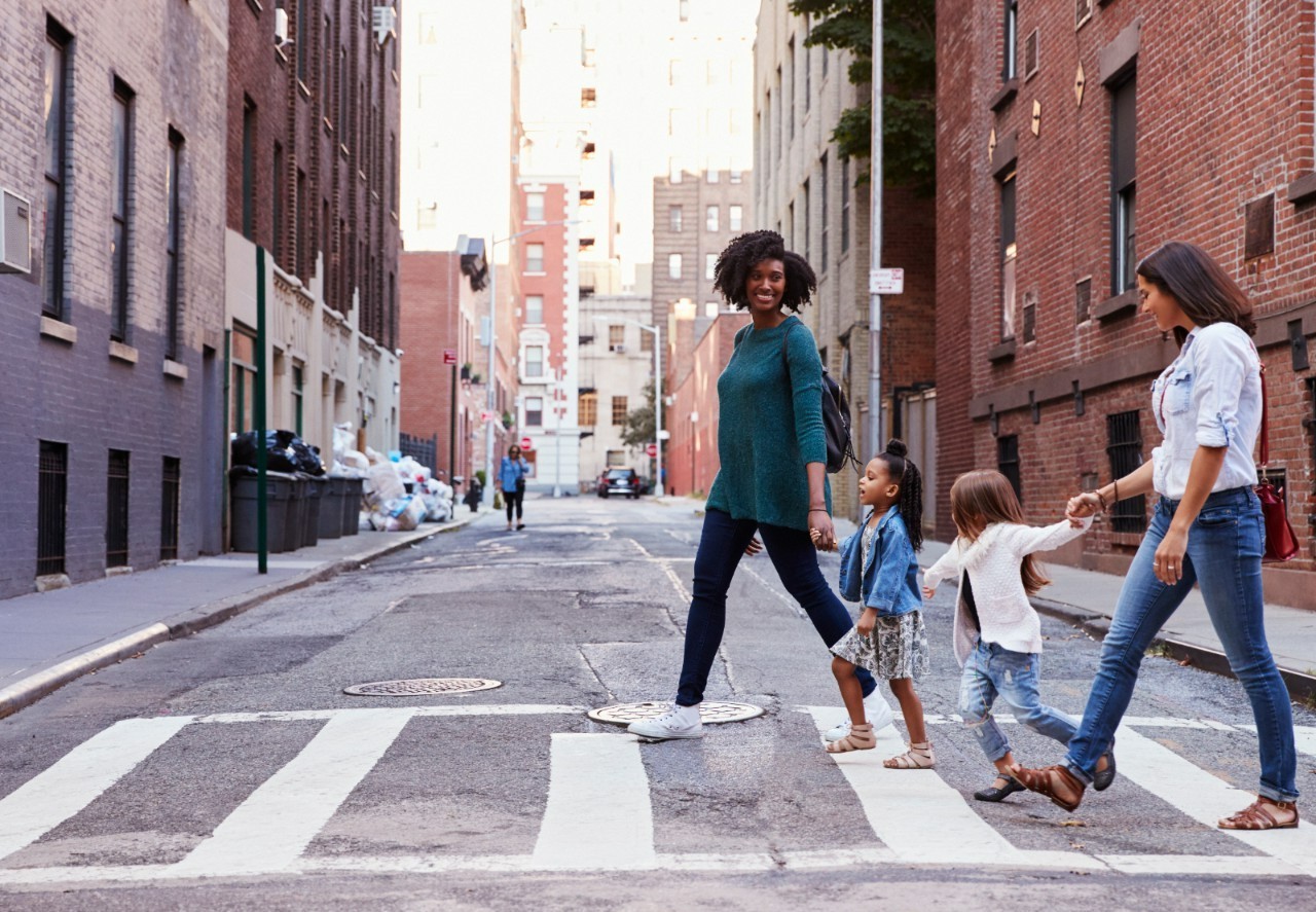 Two mother friends with two daughters crossing the road. Two mother friends with two daughters crossing the road.