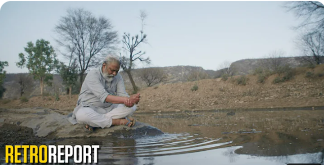 Man sitting at edge of stream. Man sitting at edge of stream.