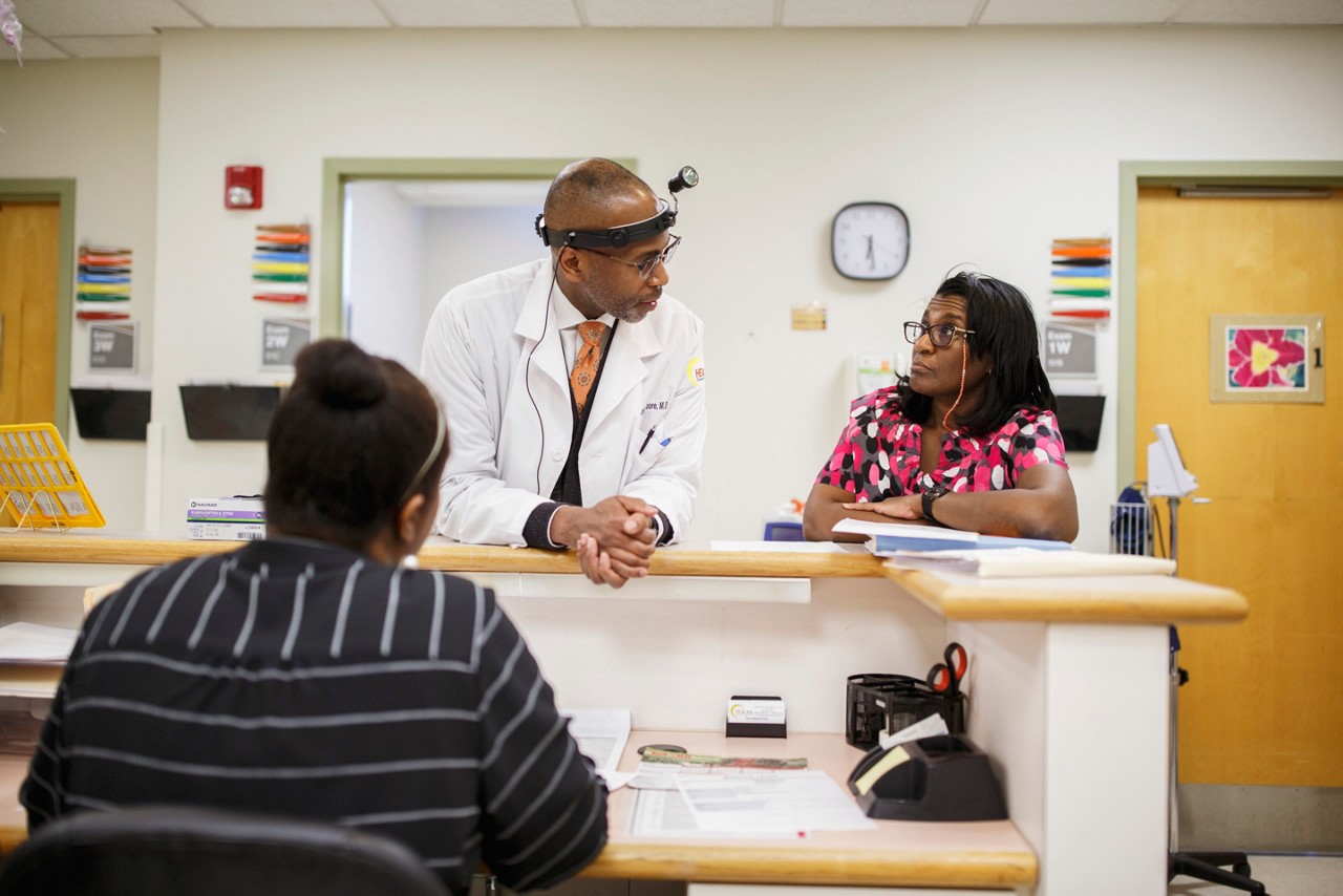 Nurses use a computer to monitor patients.