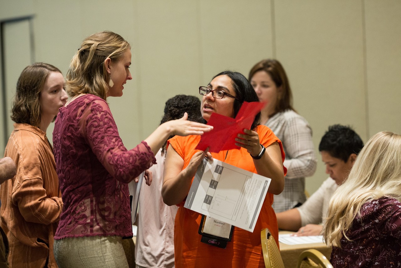 A group of students talking during a conference.