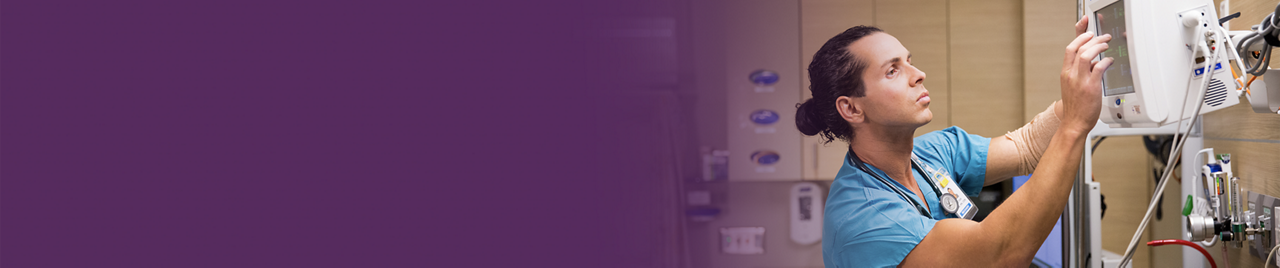 A nurse adjusts a monitor in a patient's hospital room. A nurse adjusts a monitor in a patient's hospital room.