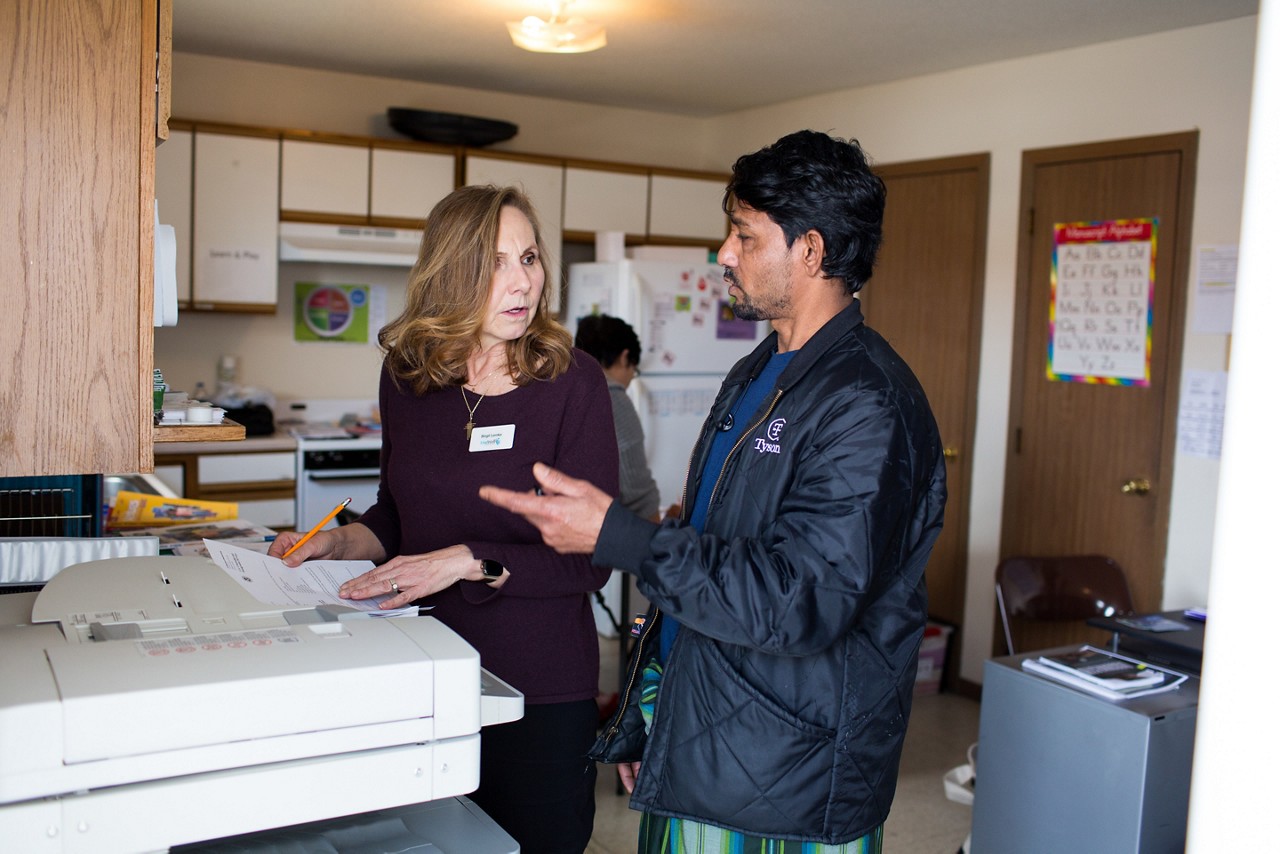 Two People Talking Birgit Lemke assists Ziaur Rahman with his tax questions at the LiveWell Finney County Neighborhood Learning Center in Garden City, Kansas. Rahman is a refugee from Myanmar and works at the Tyson Fresh Meats meatpacking plant. LiveWell helps refugees and immigrants with health care, housing and job applications and offers classes in English, nutrition and other life skills. Many of the Myanmar refugees they serve are from opposing ethnic groups.