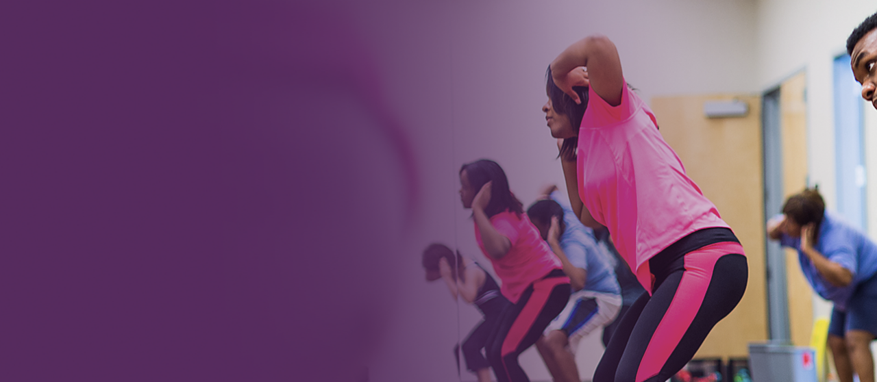 A diverse group of adults participate in a fitness class. A diverse group of adults participate in a fitness class.