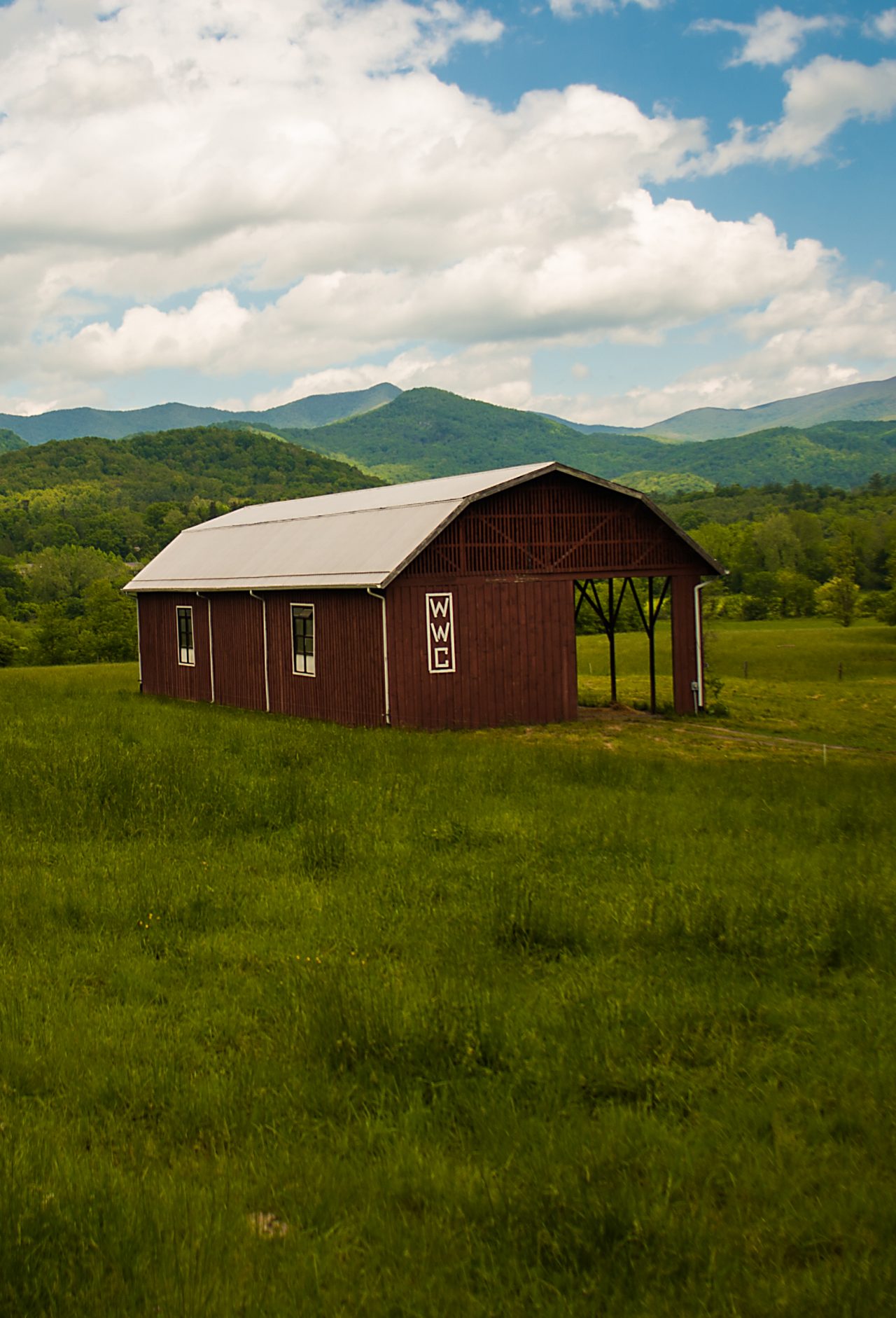 A farmhouse situated among acres of lush farmland.