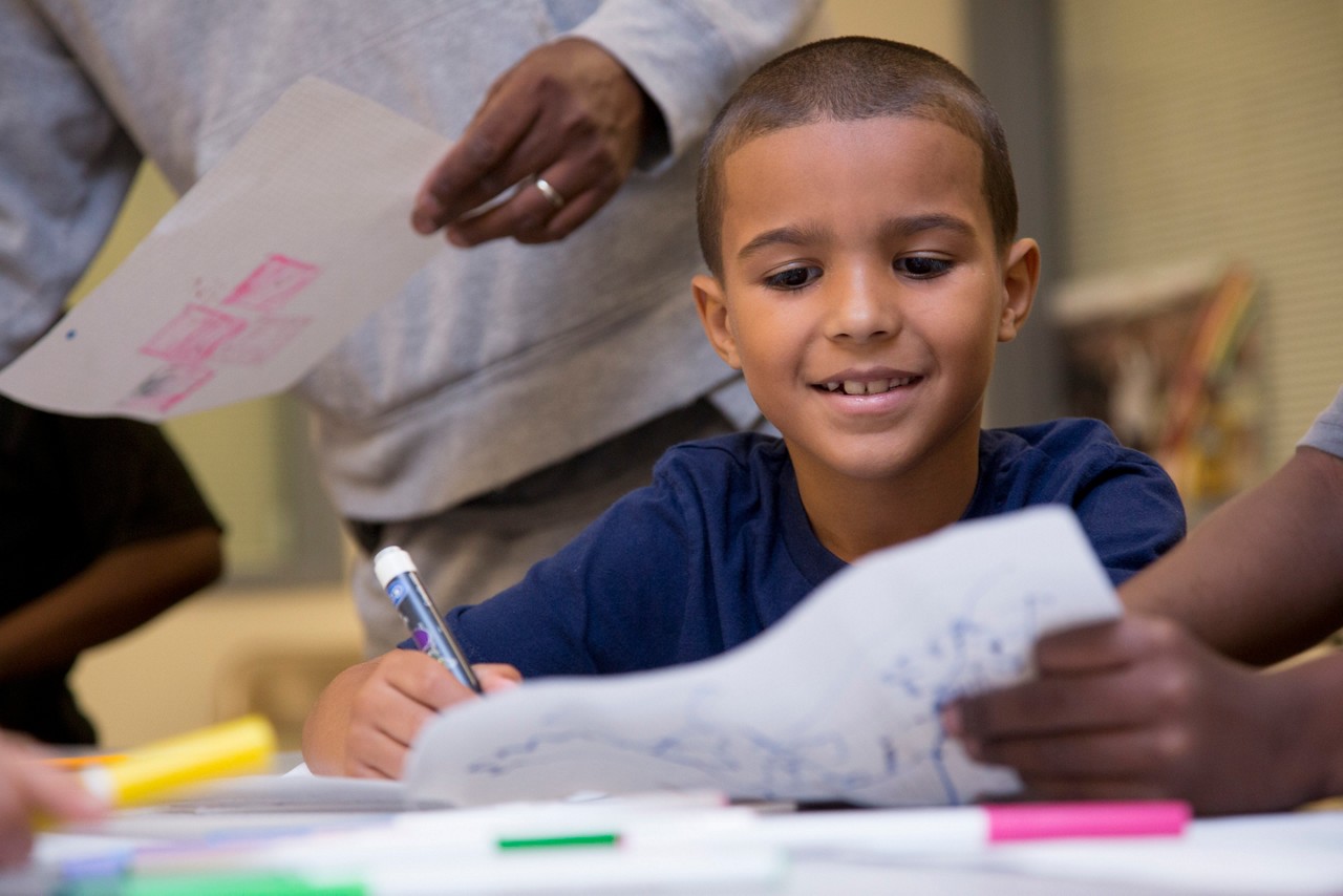 A boy drawing at STEAM camp.