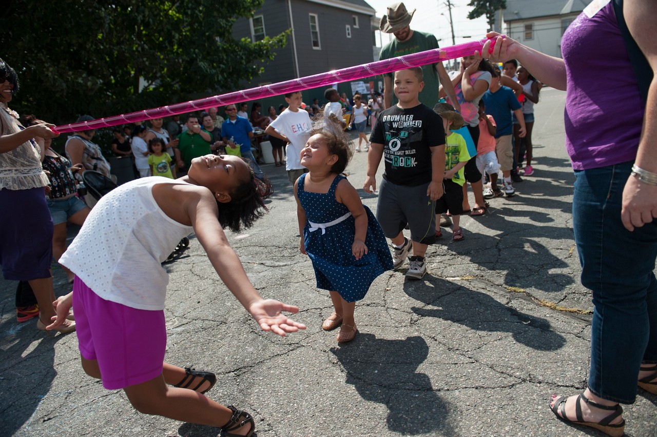 Neighborhood children doing the limbo.