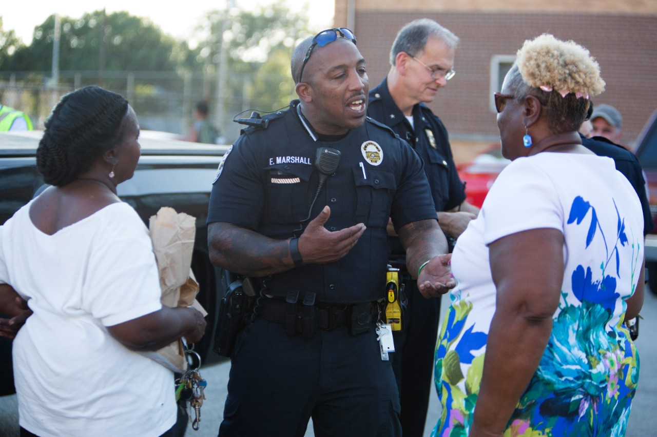 RWJF COH Louisville.  August 25-28, 2016. West Louisville Peace Walk with Louisville Metro Police Department Chief Steve Conrad and community leaders. 8/25/16.  In this photo, Officer Eric Marshall talks with neighborhood residents. tyrone@tyronefoto.com