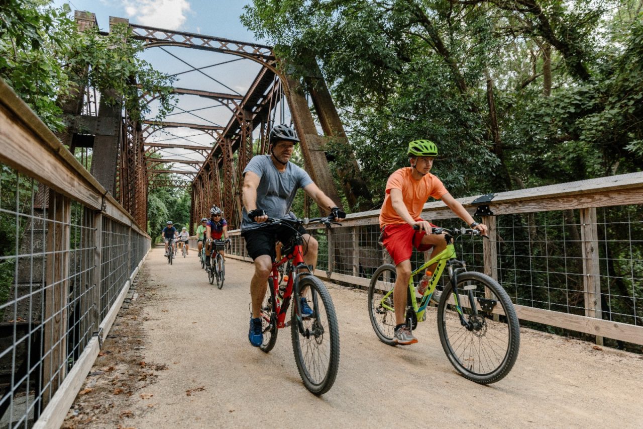 Kansas residents take a community bike ride.