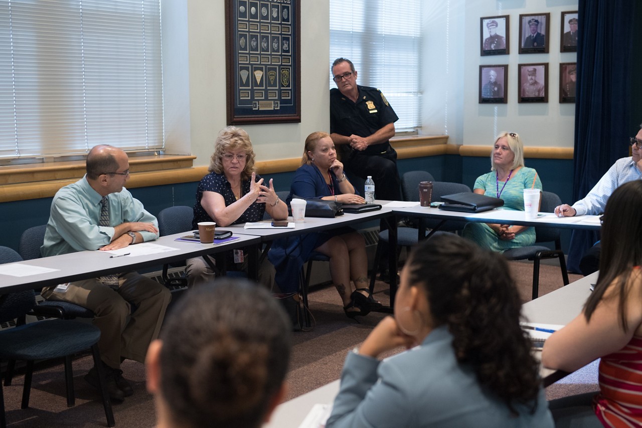 Community members gathering for a meeting.