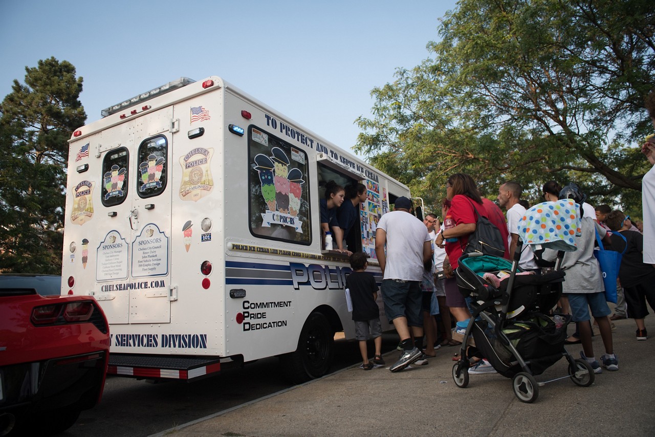 Members of the Chelsea Police Department give away free frozen treats from the department’s ice cream truck.