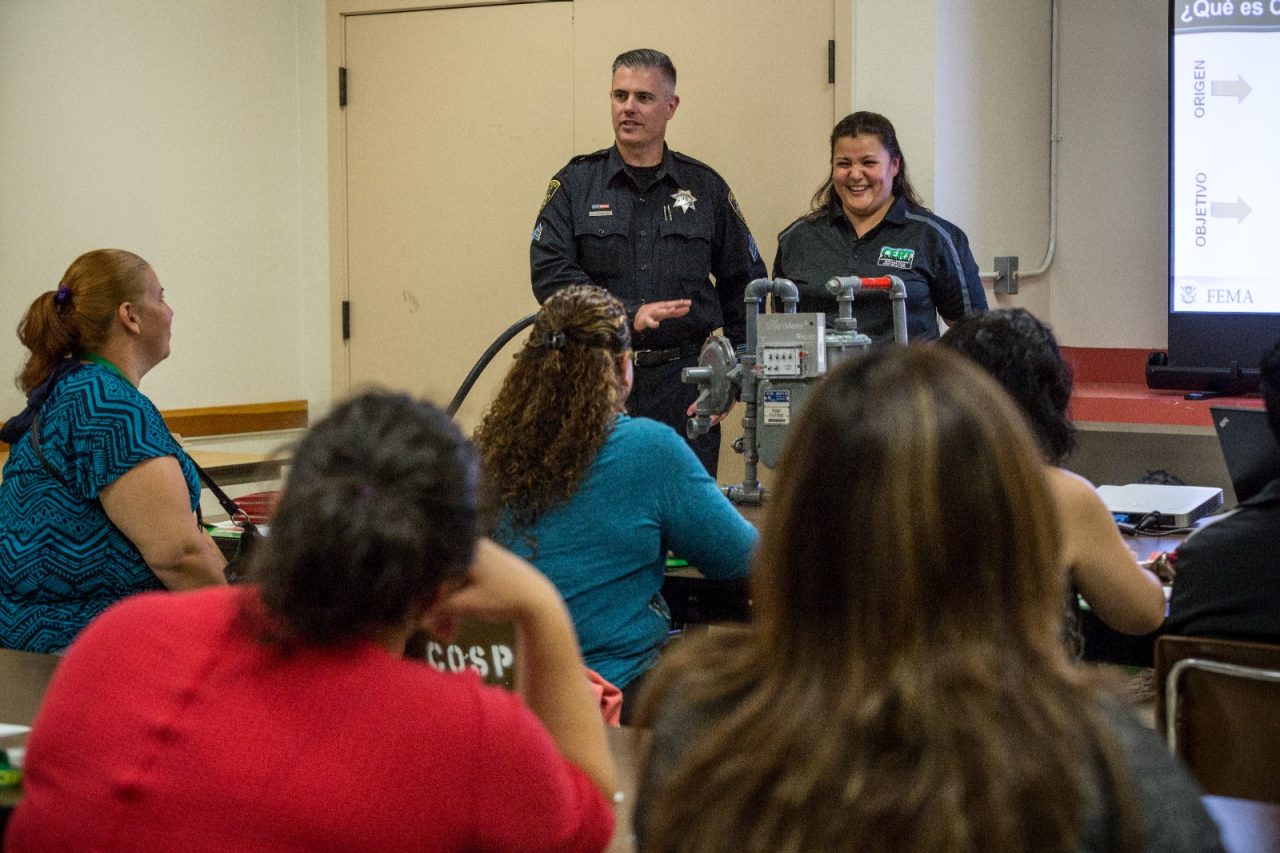 A police officer teaching a community class. 
