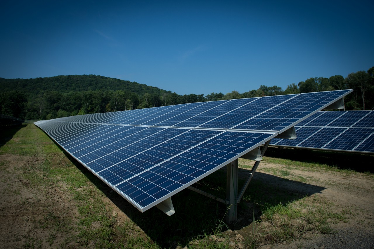 Two rows of solar panels at a solar farm. 