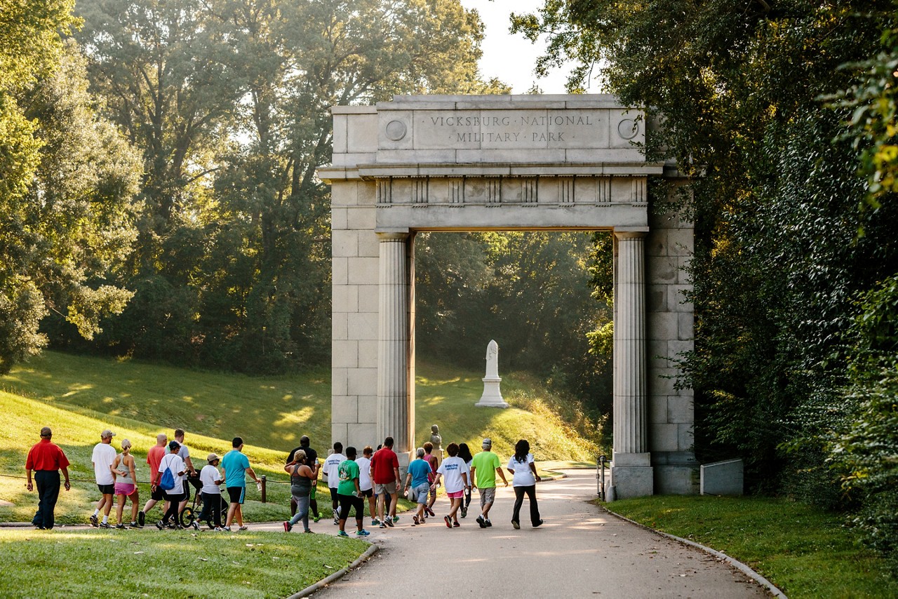 A group of people walking together in a park.