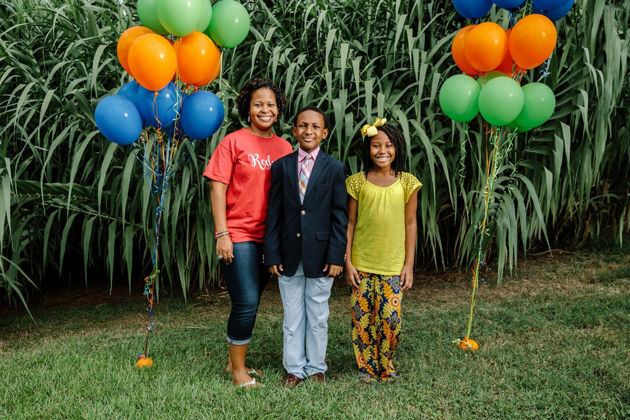 A family stands outside of the Vicksburg Convention Center. 