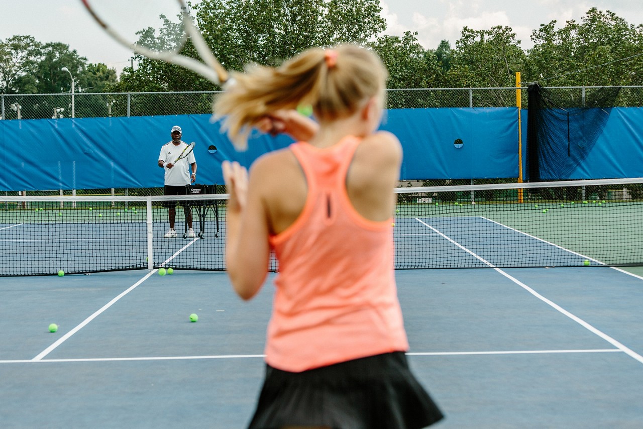 Tennis pro Rick Shields runs drills with his junior tennis team.