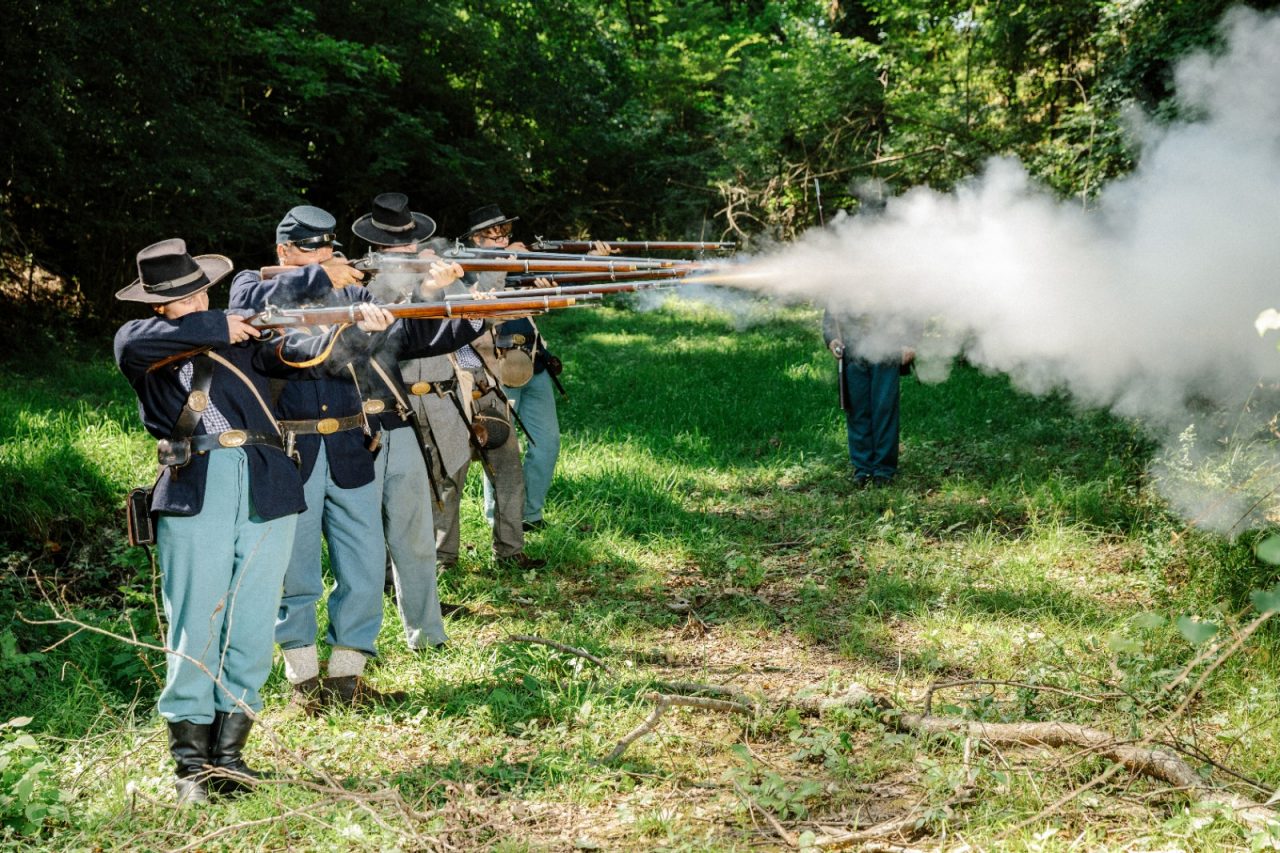 Civil War demonstrators fire their weapons.