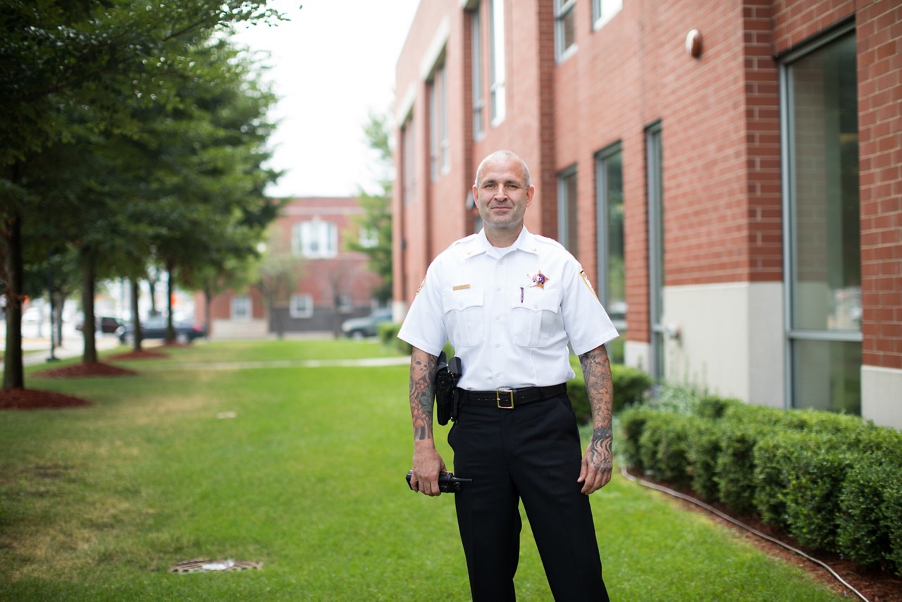 A police officer standing near a building.