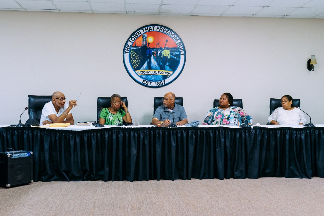 Residents attend a community meeting.