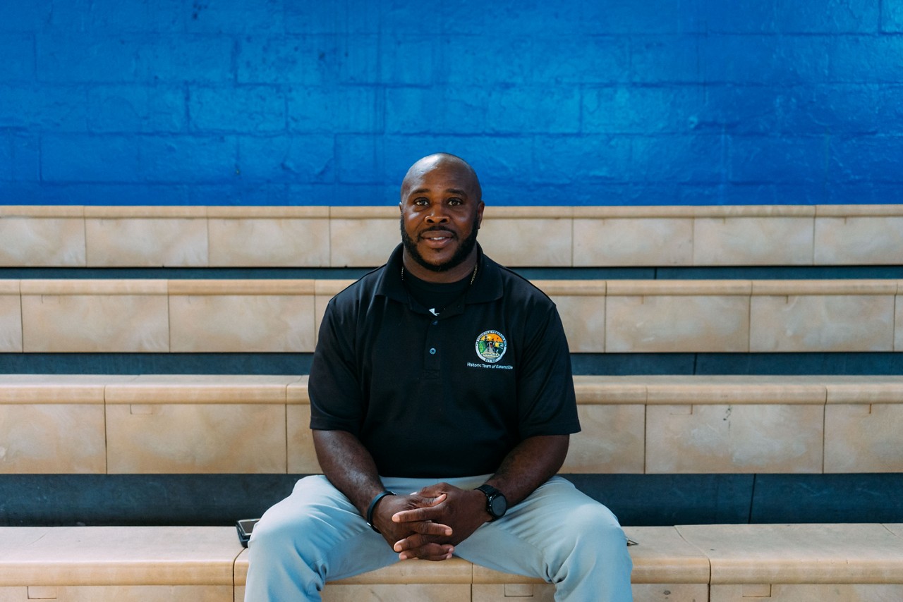 A man sitting on the bleachers.