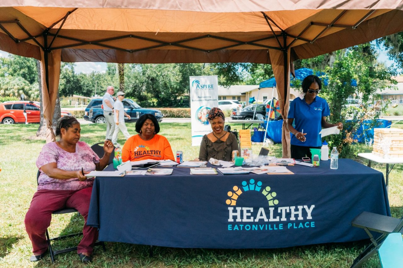 A group of women minding a health fair booth.