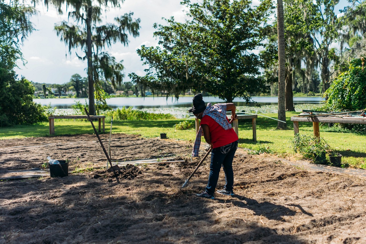 A woman preparing a garden.