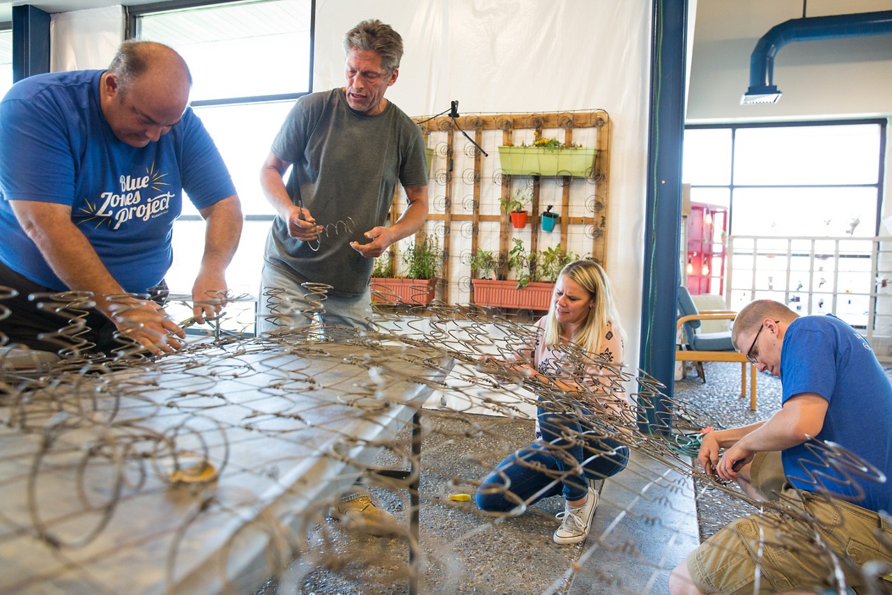 Four people working at a  mattress recycling program at Klamath Works.