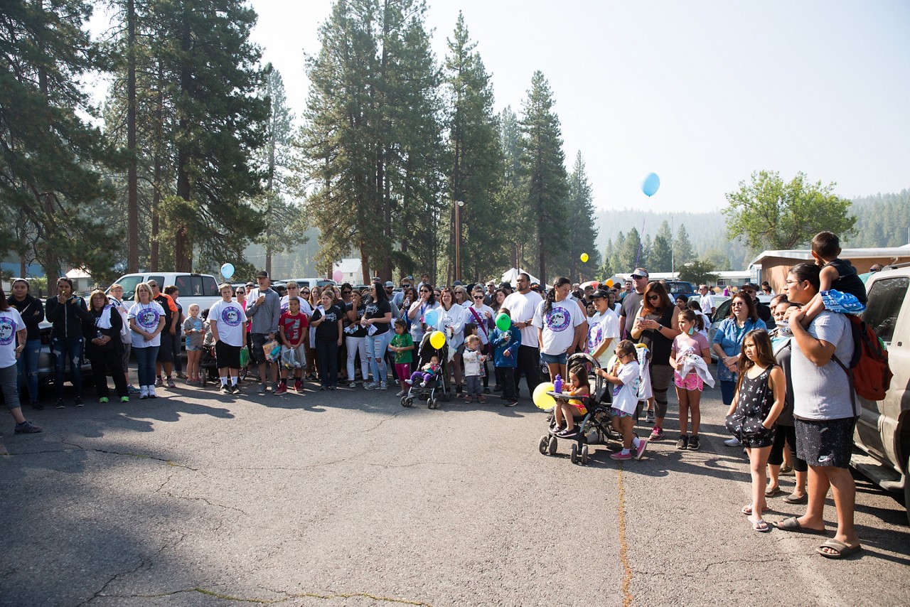 A large group gathering for an outdoor community event.