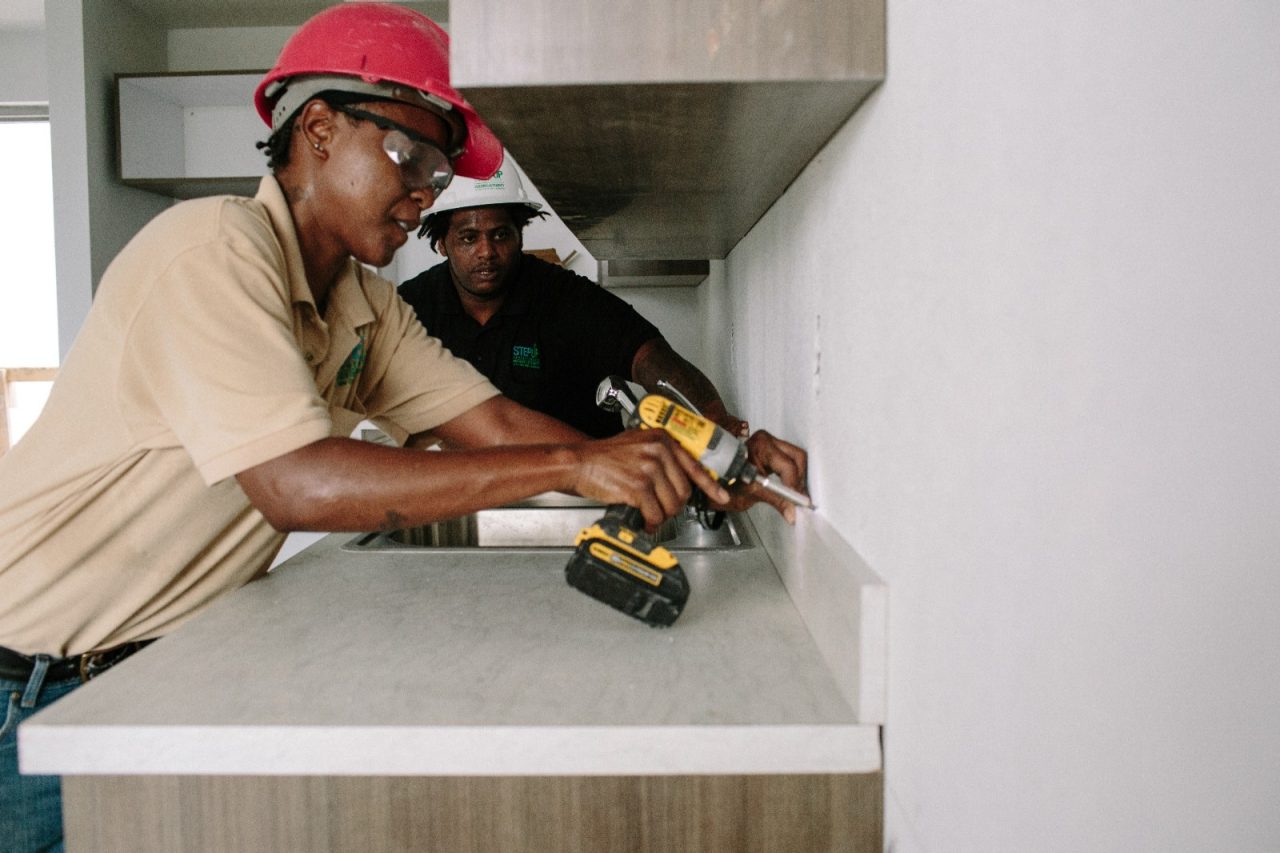 Krystal Whitt (left), 34, shows a Step-Up apprentice how to install a kitchen countertop