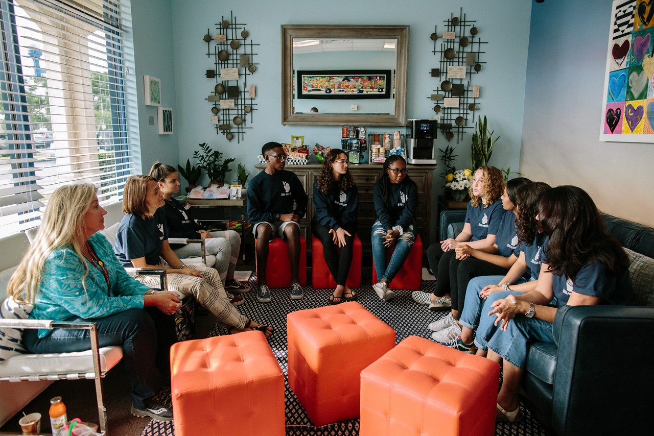 A group of high school students meeting.