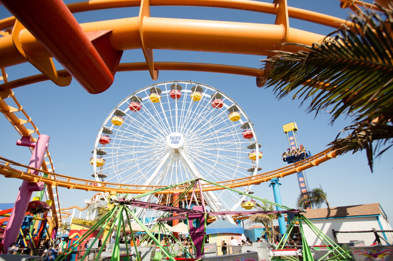 A colorful Ferris wheel on a pier.