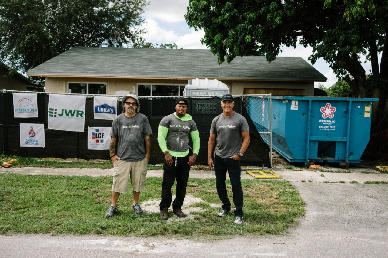 Men standing in front of a house they are restoring.
