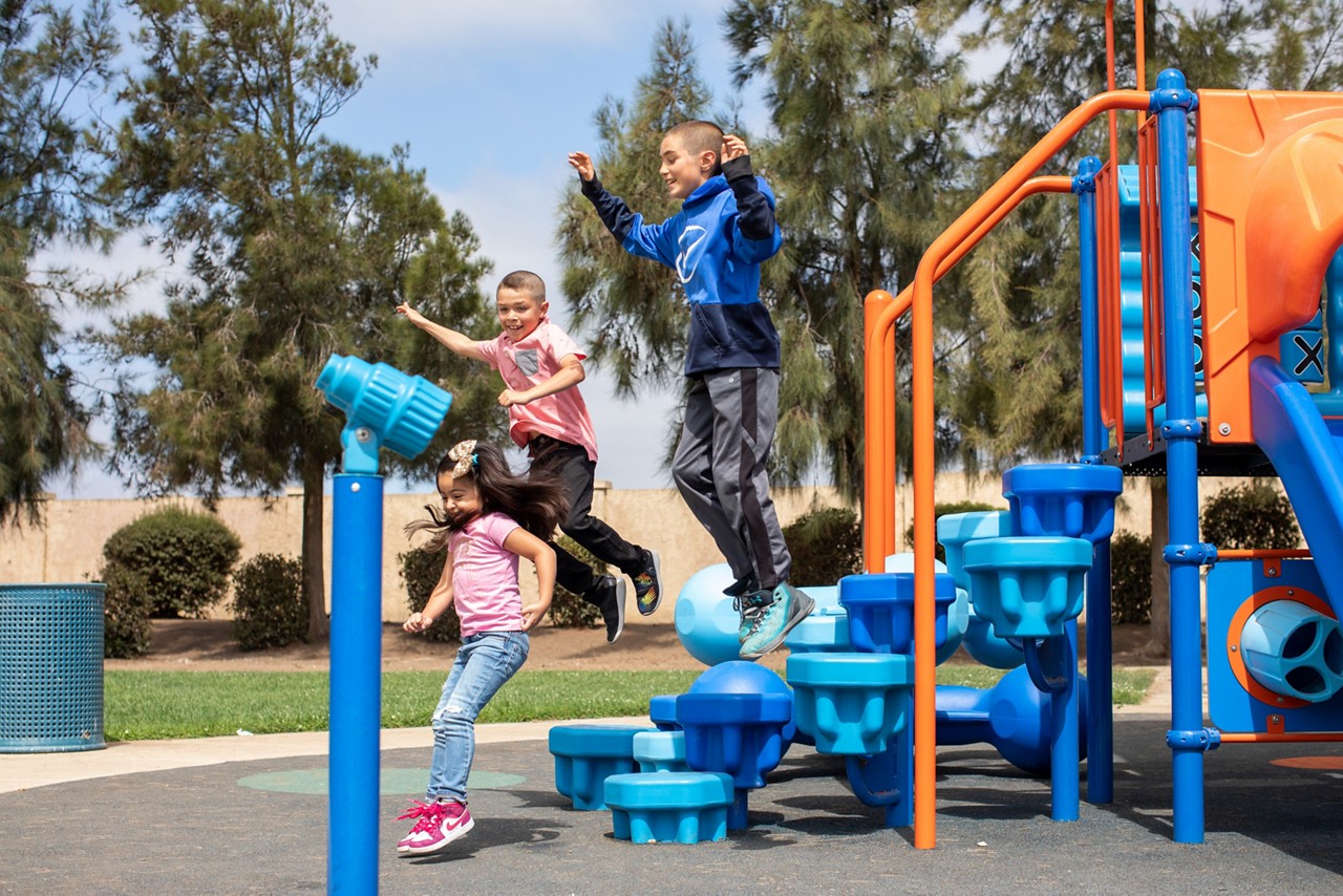 From left, Camilia Jimenez, 5, Julian Brandt, 9, and Steven Brandt, 11, enjoy the Canyon Creek Tot Lot. 