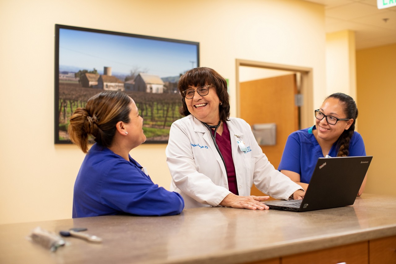 RWJF Culture of Health Prize 2019 - Gonzales, CA. Dr. Christine Ponzio (white lab coat) with nurses Patricia Perez (right) and Lorena Ortic (left) at the Taylor Farms Family Health and Wellness Center. Opened in November 2015, the Taylor Farms Family Health and Wellness Center is designed to provide state-of-the-art care. The 6,400 square foot facility employs four bilingual medical providers and is supported by a bilingual staff in order to better accommodate  communication needs. In partnership with Dr. Christine Ponzio. The center focuses on prevention, wellness and disease management. the center has over 25,000 visits a year.