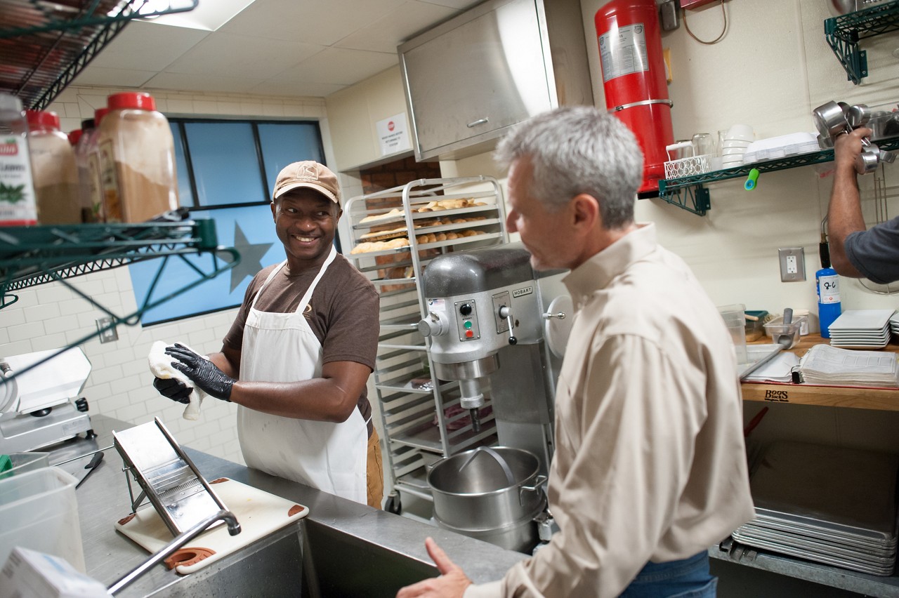 Fredrick Turner (left) prepares food at Kitchen Sync.