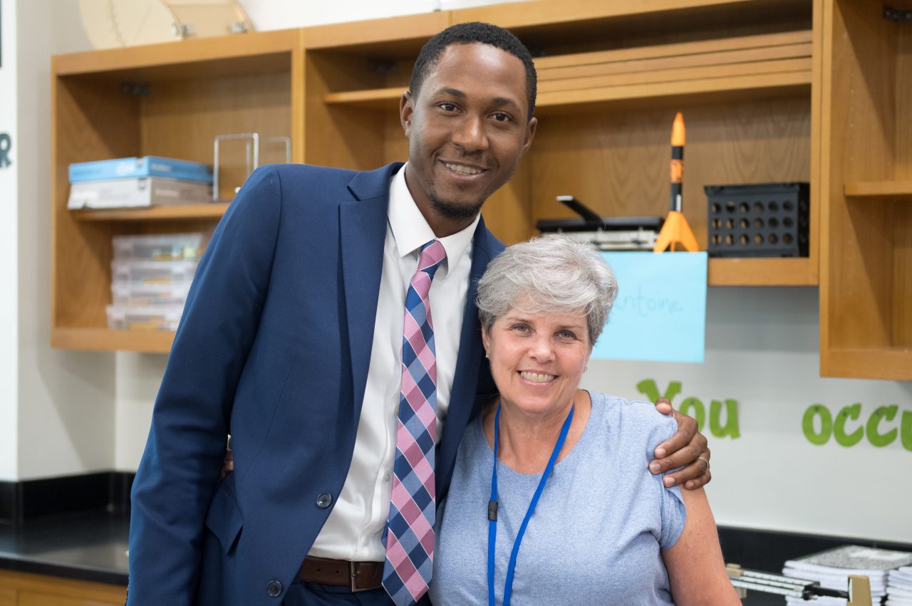 Principal Edward J. Anderson hugs his fourth grade teacher, Susan McCoy, who had a great impact on his development as a student. She is now a science teacher at Tanglewood Middle School, which is participating in the OnTrack Greenville program to identify risky behaviors and better engage students.