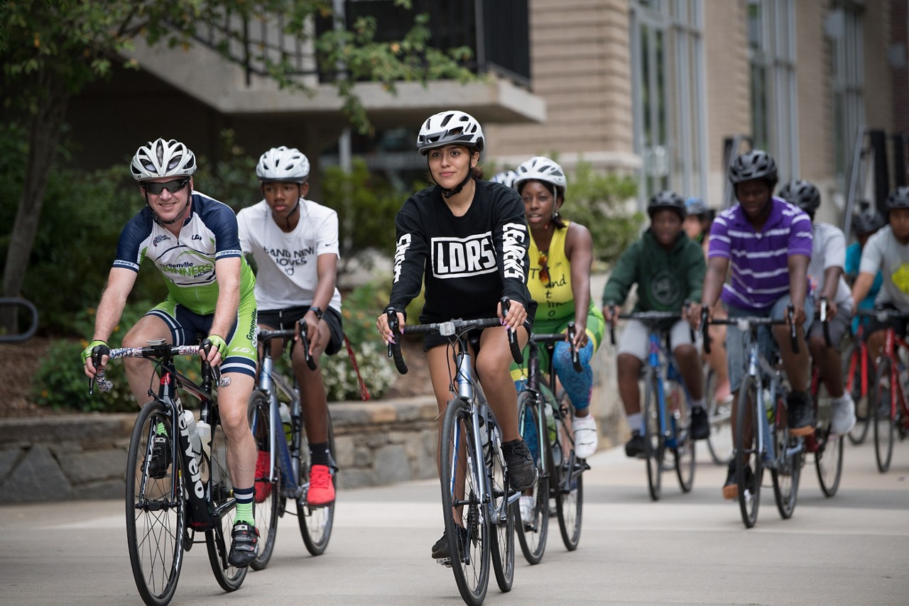 Members of the Momentum Bike Club ride through downtown Greenville on the Swamp Rabbit Trail.