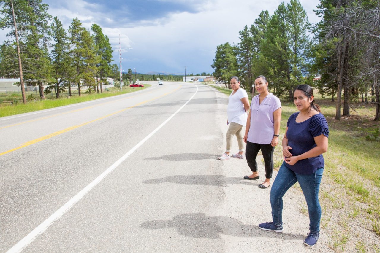 Three women stand on the busy state-owned highway next to the Mountain View manufactured housing community in Lake County, Colo.