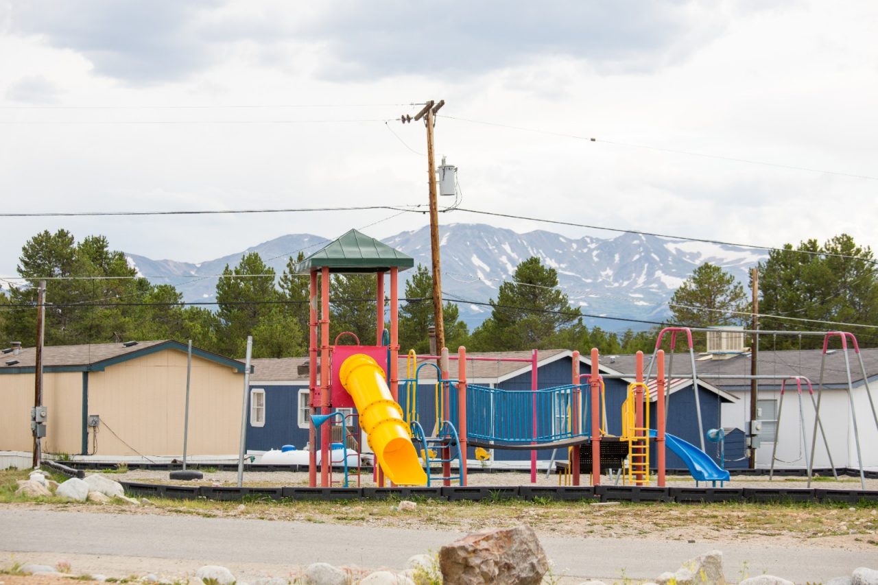 A playground at the Mountain View manufactured housing park in Leadville, Colorado.  Several residents who participated in the Family Leadership Training Institute 20 week civic engagement program have raised community support to build a new playground at the housing park, worked with the fire department to install fire and carbon monoxide detectors and advocated for a safe pedestrian crossing on the state-owned highway.